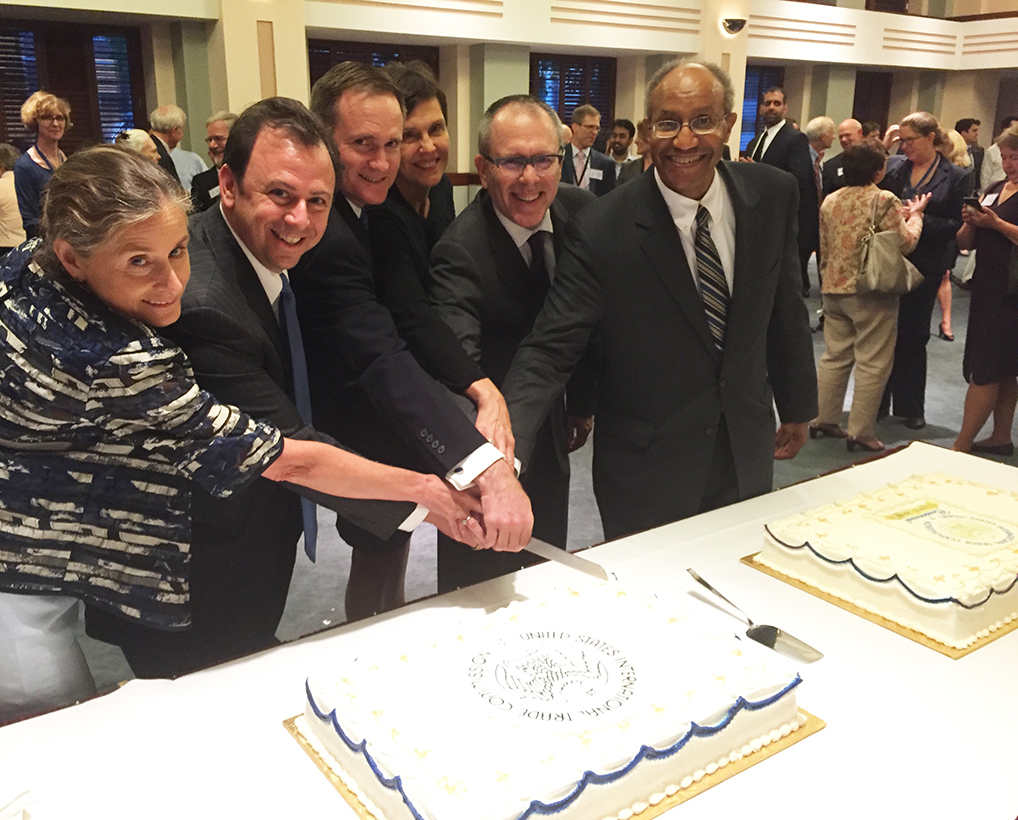 All current Commissioners cutting the USITC Centennial cake at the  reception. Shown from left to right are Commissioners Broadbent and  Kieff, Vice Chairman Johanson, Commissioners Schmidtlein and Pinkert, and Chairman Williamson. 