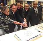 All current Commissioners cutting the USITC Centennial cake at the  reception. Shown from left to right are Commissioners Broadbent and  Kieff, Vice Chairman Johanson, Commissioners Schmidtlein and Pinkert, and Chairman Williamson. 