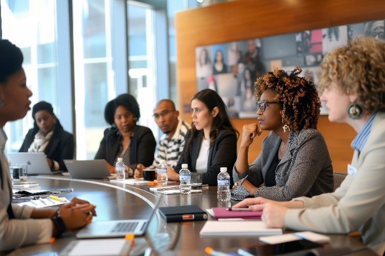 Workers sitting at a conference table for a meeting.