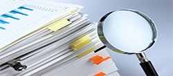Research documents with magnifying glass
